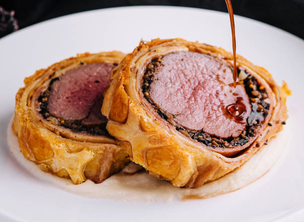 Fillet wellington in puff pastry on plate stock photo