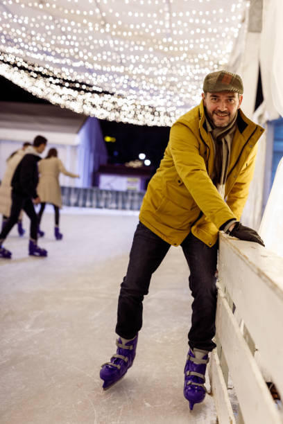 istock Man holding the railing and learning how to ice skate 1471866986