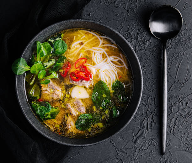 istock Chicken soup with vegetables in black bowl 1471867082