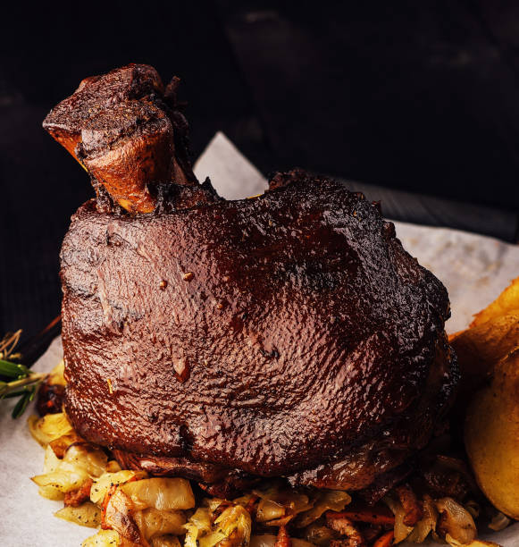 istock Roasted pork knuckle eisbein with on wooden cutting board 1471867206