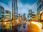 Futuristic architecture of London financial district illuminated in early evening