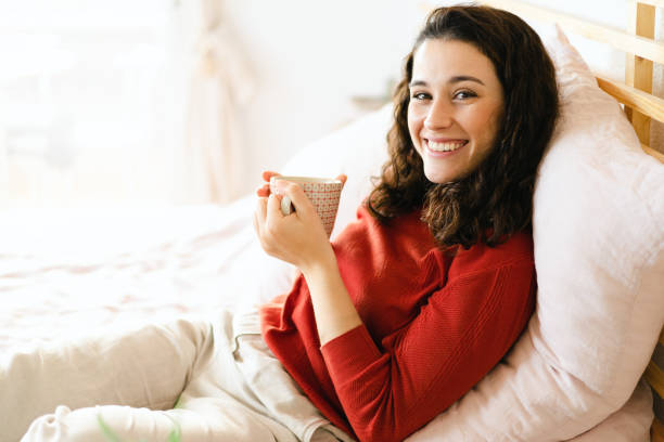 istock Happy woman having a coffee on the bed 1471869533