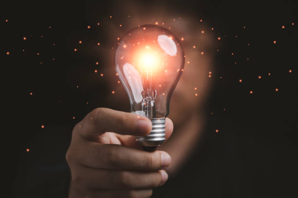 istock Businessman holding glowing lightbulb to creative smart thinking idea for inspiration and innovation concept. 1471870603