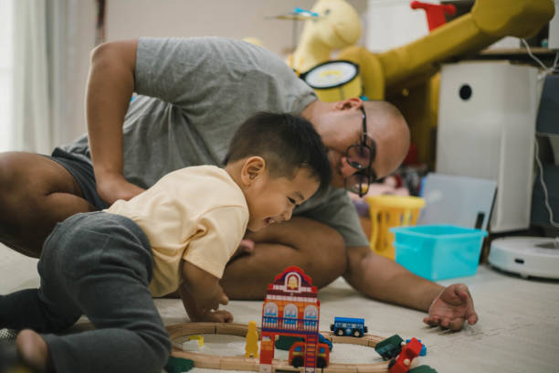 istock asian father and small son playing at home 1471873862