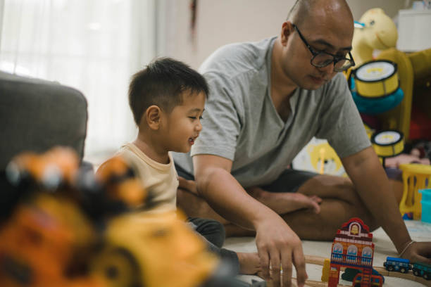 istock asian father and small son playing at home 1471873863