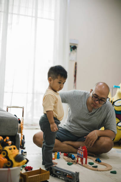 istock Single father playing with toys with son 1471873892