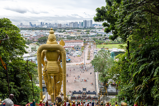 12/09/2022- Batu Caves, Kuala Lumpur, Malaysia.\nRear view from the top of the staircases looking out at the city skyline