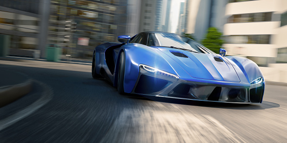 Low angle view of a generic silver blue sports car cornering at speed on a domestic road at an intersection in a downtown city location with large buildings and offices on a bright day. With motion blur to the road and background.