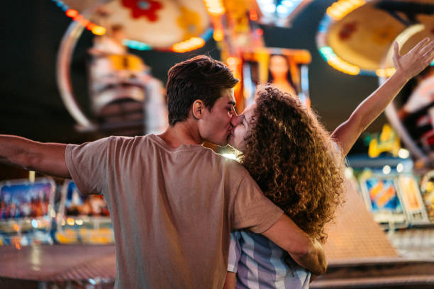 istock Young Couple Kissing In Amusement Park 1471876182