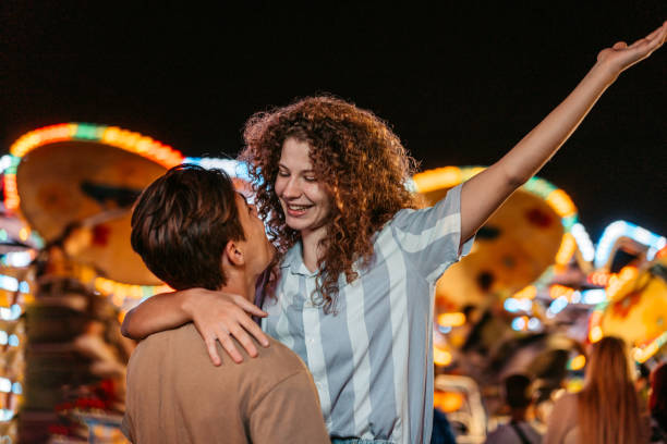istock Young Couple Embracing Each Other  In Amusement Park 1471877312