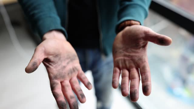 Man shaking off his dirty black hands in dust closeup 4k movie slow motion