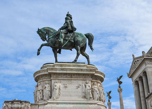 Ancient statue of Vittorio Emanuele II on a horse overlooks the Piazza Venezia in Rome, Italy.