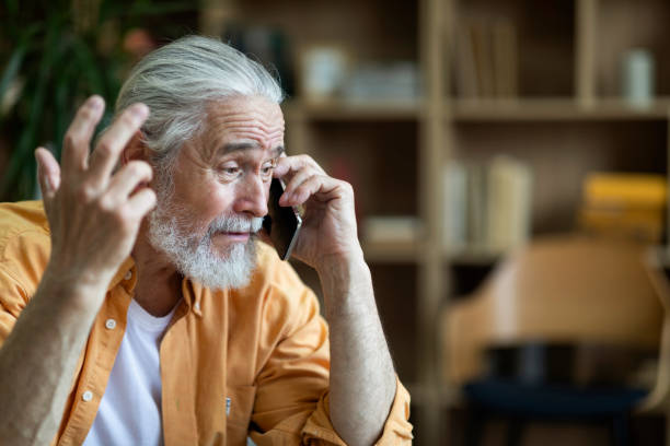 istock Emotional old man having phone conversation, gesturing 1471882983