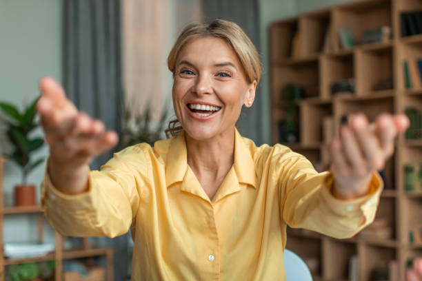 istock Happy female teacher talking to camera, teaching online, gesturing hands and smiling 1471883040