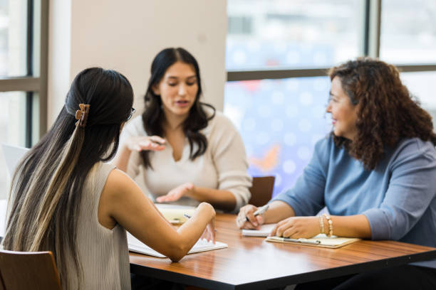 istock Focus on unrecognizable businesswoman in foreground during meeting 1471886607
