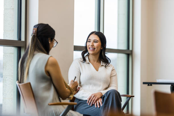 istock Female therapist takes notes as young female client shares 1471886637