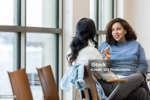 Unrecognizable Female Client Listens As Female Counselor Gives Advice Stock Photo - Download Image Now