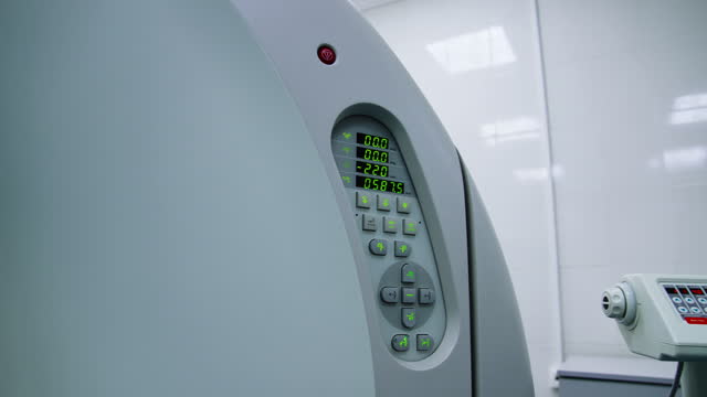 Keyboard panel at the modern technological equipment for magnetic resonance imaging. Switched on machine of computed tomography.