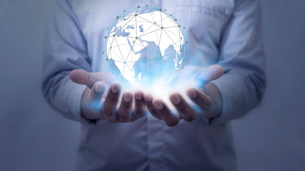 istock Businessman holding globe on blurred background 1471892123