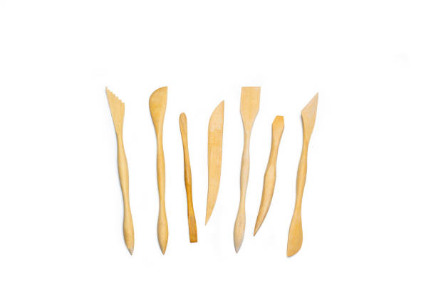 Wooden pottery spatulas on a white background with copy space