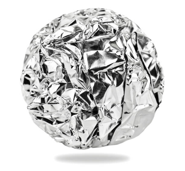 Foil aluminum crumpled ball on white stock photo