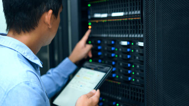 System administrator working with tablet in data center. stock photo