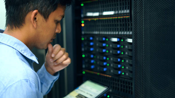 System administrator working with tablet in data center. stock photo