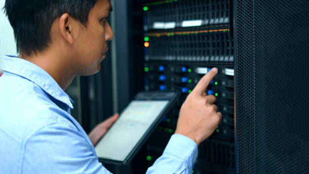 System administrator working with tablet in data center. stock photo