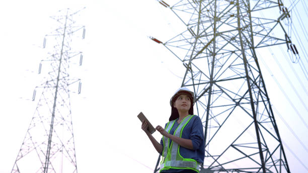 istock Specialist electrical engineer working near to High voltage tower. 1471895059