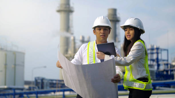 Two industrial engineer working near the electrical plant. stock photo