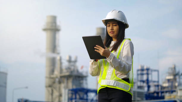 istock Industrial engineer using digital tablet for work against the background of electrical power plant. 1471895077