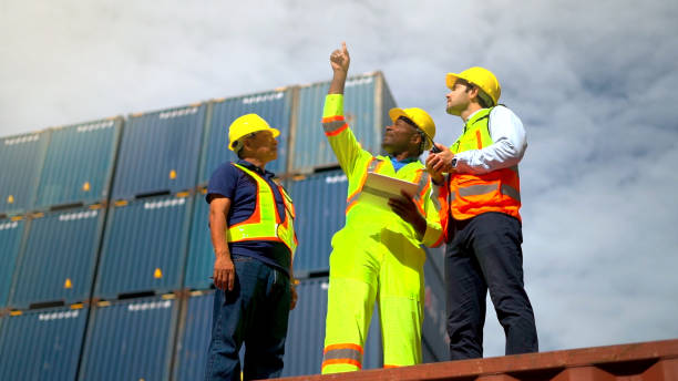 Logistic staffs survey load container for shipping plan in Logistic area company. stock photo