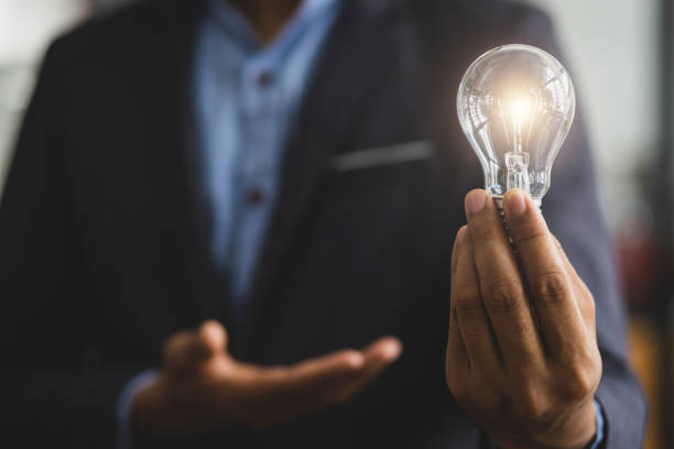 istock Businessman holding a light bulb, concept of idea. 1471895808