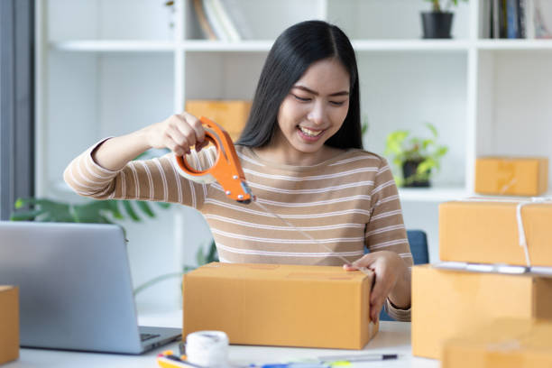 istock Small start-up business woman working with parcel boxes packing goods in preparation for delivery of customer orders. Retail and wholesale seller concept in e-commerce marketplace. 1471896014
