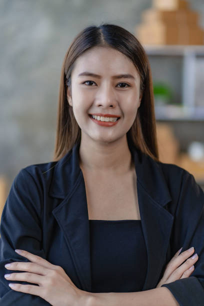 istock Asian young woman working from home with boxes, checking orders and preparing to deliver packages, SME online business concept 1471896734