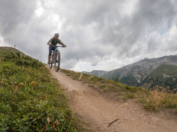 istock Man mountain biker rides along trail in Summer 1471904175