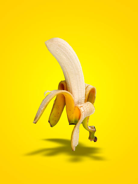 istock Banana Peel  with shadows on yellow gradient 1471904280