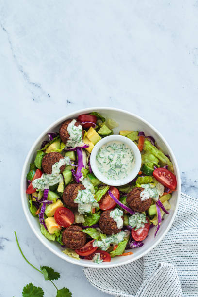 istock Falafel salad with avocado, tomato and tahini dressing. 1471905137