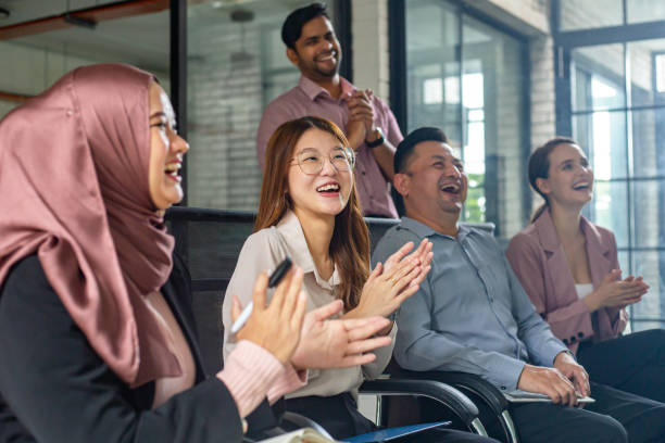 business team clapping hands in meeting - office fun group of people white collar worker imagens e fotografias de stock