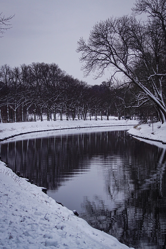Scenic view of canal against sky during winter