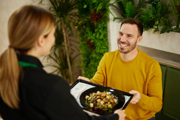 istock Mid adult man getting a custom salad made at a salad bar 1471905903