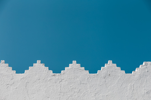 view of triangular white wall against blue sky - Asilah, Morocco