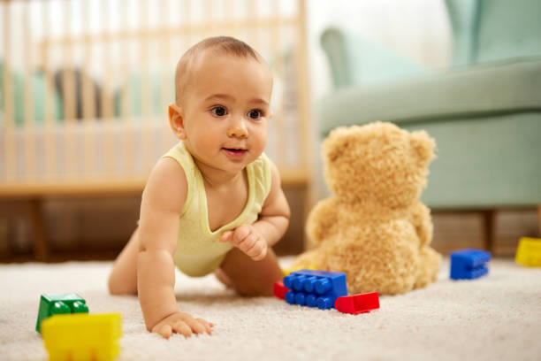 Cute little baby boy, playing at home, crawling