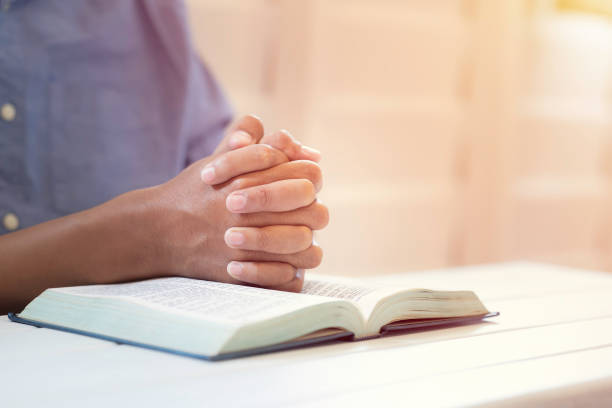 istock Man's Praying Hands Over The Bible. 1471906613