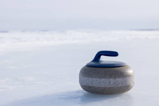 istock Blue handled curling rock on outdoor ice 1471908137