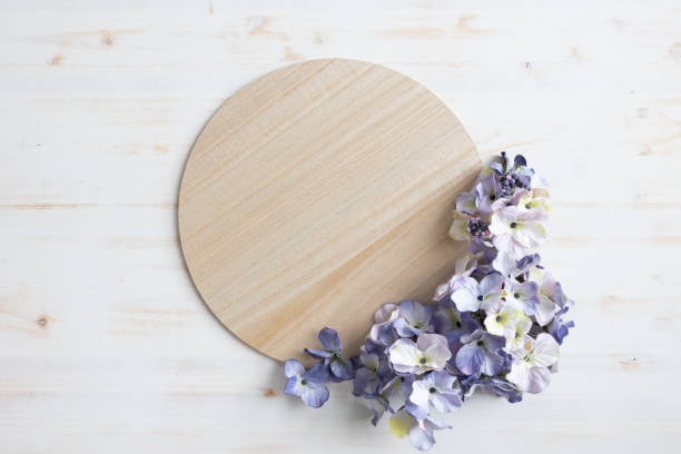 istock Light wood disk framed by purple flowers 1471908170