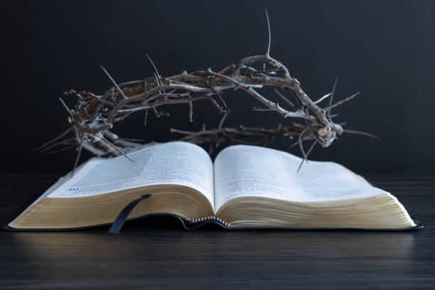 istock Crown of thorns on an open bible with a black background 1471908548