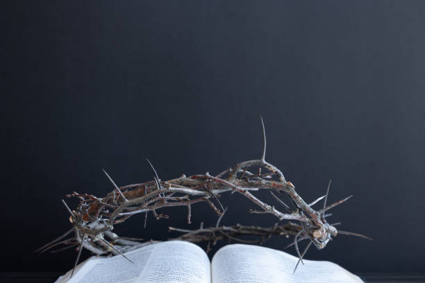 istock Crown of thorns on an open bible with a black background 1471908552