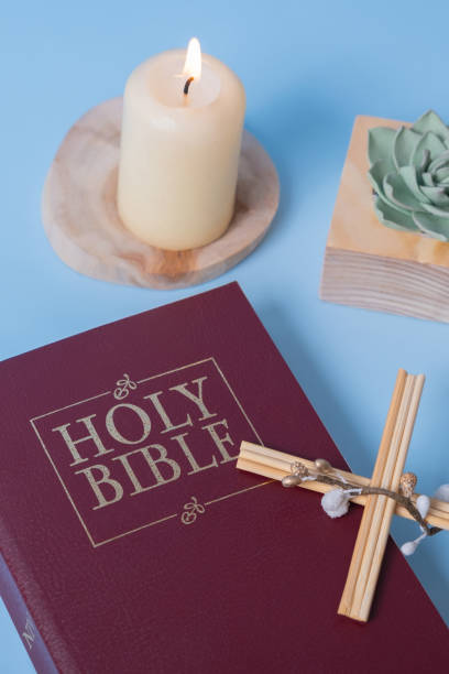 istock Christian Holy Bible with candle on blue background, flat lay, top view 1471909450
