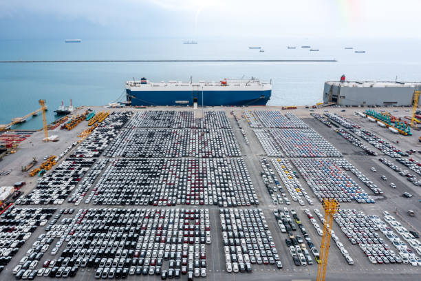 istock Large RoRo (Roll-on Roll-off) into Commercial dock loading new car product order for sale for export international on the sea, business service transportation concept, photograph Drone 1471913353